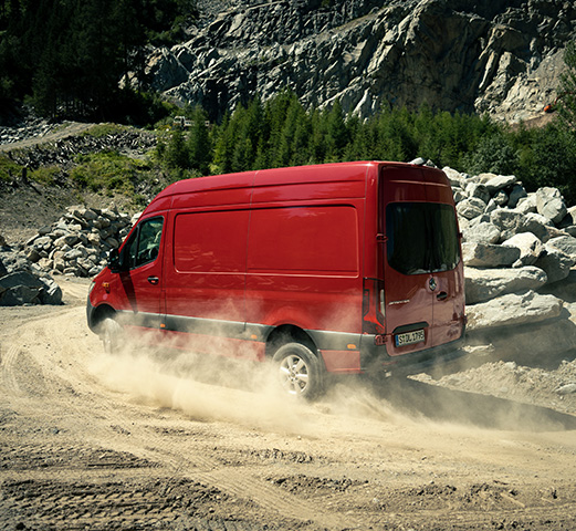 A Mercedes-Benz Adventure Van driving up a steep hill with all-wheel drive. 