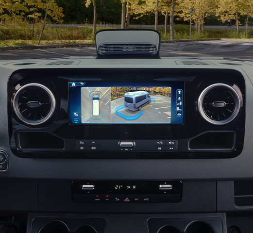 A person driving a Mercedes-Benz Adventure Van in reverse gear using the 360° Camera.